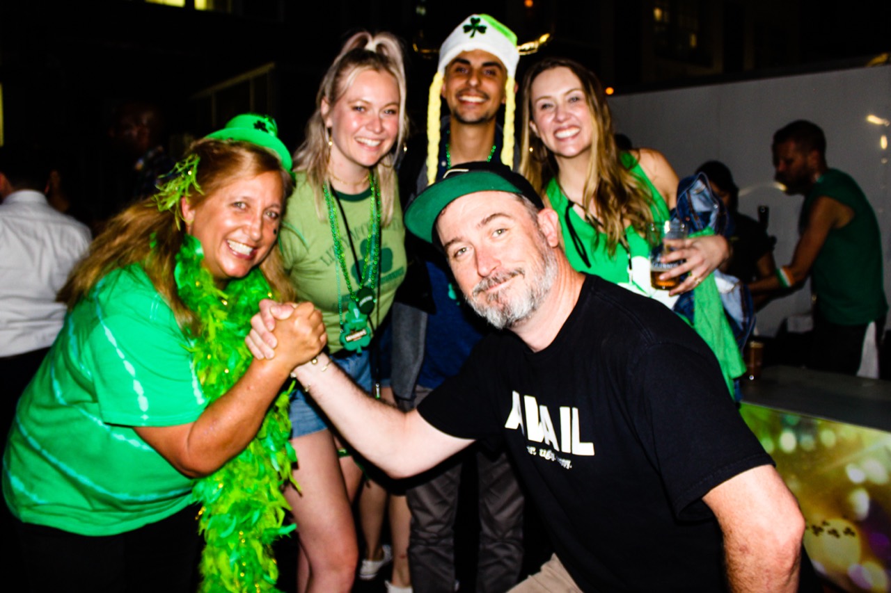 Roger and Karen posing with a group during a celebration.